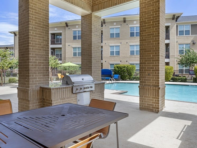 our apartments have a large patio with a grill and a swimming pool